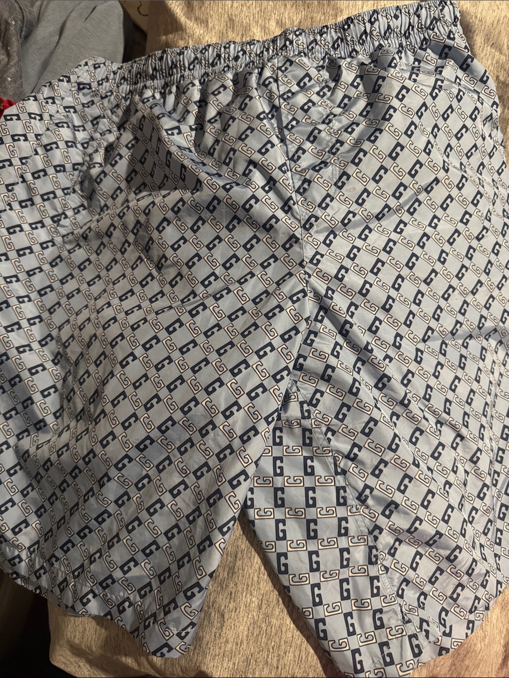 Gucci Men's White and Navy Interlocking G Swim Trunks.